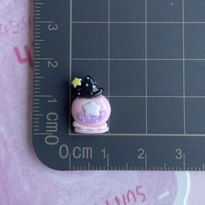 Close-up of pink resin potion bottle with wizard hat showing small 1.5cm size scale
