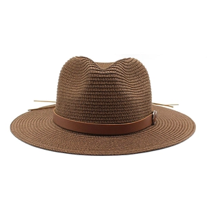 Close-up of retro tan panama straw hat with tight weave and brown leather belt detail