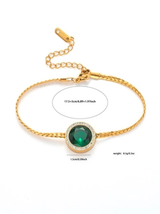 Detail of gold titanium steel bracelet with green gem and lobster clasp closure