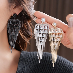 Detailed view of luxury long tassel rhinestone earrings in black, gold, and silver colors