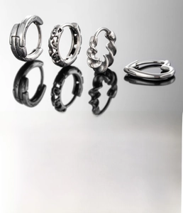 Detailed view of silver titanium steel hoop earrings with twisted and geometric designs
