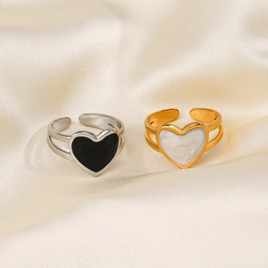 Set of 18K gold and silver plated stainless steel heart rings on silk background