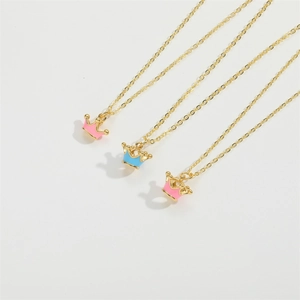 Three dainty crown necklaces with pink and blue devil eye pendants on gold chains