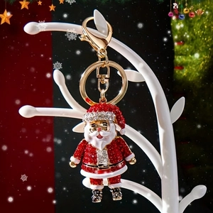 Sparkling Santa Claus keychain with red and white rhinestones on a festive display
