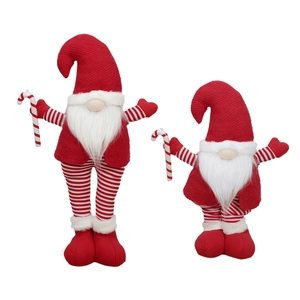 Christmas red and white knitted gnome figurines with candy canes on white background