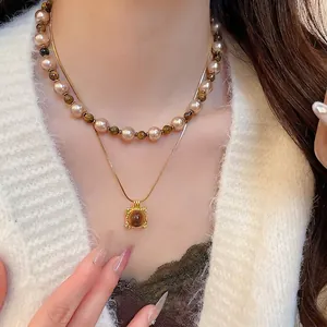 Double-layered tiger eye pendant and pearl necklace with golden snake chain for women