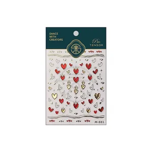 Romantic gold and red heart nail art stickers with crown designs on green backing card