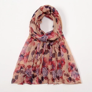 Detail of floral printed voile scarf showing red and purple roses on beige fabric