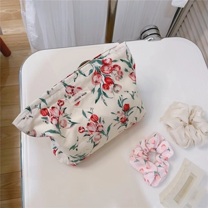 Macro detail of retro floral cotton makeup bag with tulip print and simple label