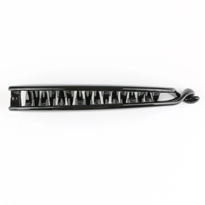 Macro view of a black plastic banana hair clip with multi-tooth design on white background