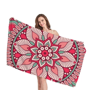 Thick mandala beach towel with colorful geometric bohemian pattern and fringe