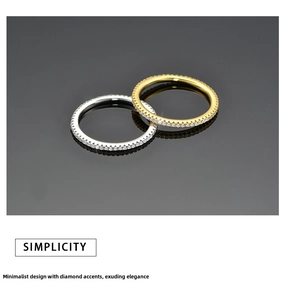 Close-up of interlocking silver and gold minimalist rings with pavé cubic zirconia