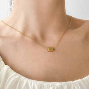 Detail showing mini 18k gold plated bar pendant with Fine Gold 999 engraving