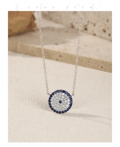 Close-up of S925 silver necklace with blue sapphire and zircon micro-pave pendant