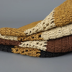 Detailed macro view of hand-woven straw bucket hats showing textured crochet patterns
