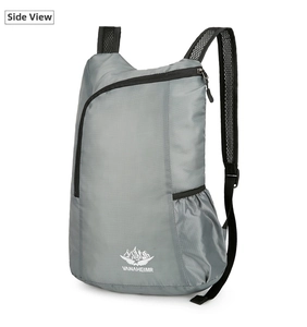 Close-up of grey lightweight foldable backpack showing ripstop fabric and mesh straps