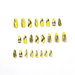 Almond-shaped press-on nails with yellow base and geometric black swirl line patterns