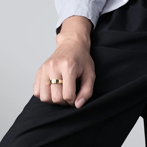 Macro shot of rotatable gold spinning ring with cross pattern and polished finish