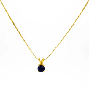 Gold twisted rope chain necklace with a round deep blue birthstone pendant in 4-prong setting
