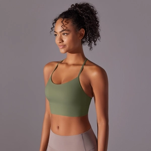 Detail of olive green sports bra featuring cross-back straps and brushed elastic fabric
