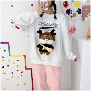 Cute squirrel plush crossbody bag with glasses and chain strap shown on a female model
