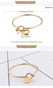 Detail of 18K gold-plated open bangle featuring a heart pendant and dimensions view