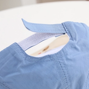 Detail of baby sun hat showing adjustable velcro strap for customized head size fit