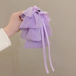 Detailed close-up of a lavender layered chiffon bow hair claw clip with long ribbons