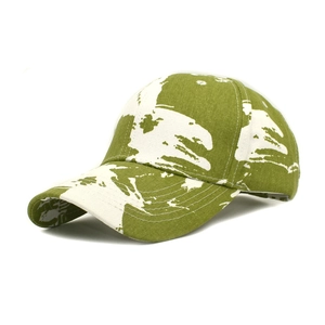 Detail of green and white tie-dye baseball cap with thick twill cotton texture