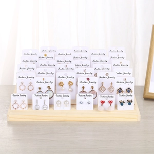 Solid wood earring display stand showcasing various gold and pearl jewelry designs