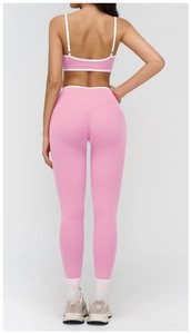 Rear view of a pink high-waisted yoga set with white trim detail for athletic women