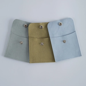 Three premium microfiber velvet jewelry pouches with snap buttons in soft earth tones