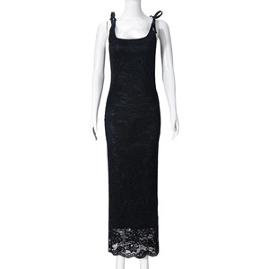 Detail of black lace maxi dress with bow shoulder straps and sheer floral hemline
