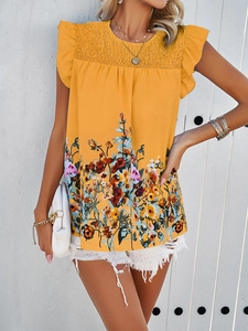Detailed view of women's yellow floral sleeveless top with ruched bust detail on model