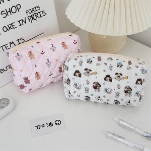 Close-up of quilted pencil cases with cute cartoon bear and cat patterns and zipper