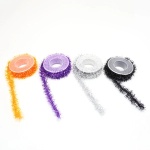 Detail of Halloween tinsel garlands in orange, purple, silver, and black metallic finish