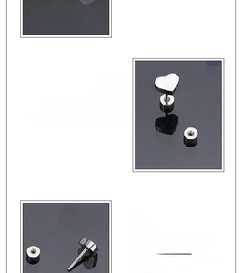 Macro view of heart-shaped stainless steel stud earrings showing polished finish and screw back