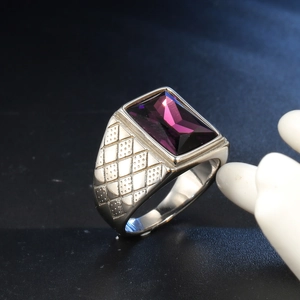 Macro shot of silver men's square ring with purple gemstone and textured band