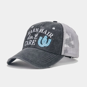 Detail of embroidered ponytail baseball cap with breathable mesh and vintage washed fabric
