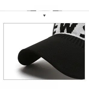 Detail of knitted visor with black and white NEWS pattern and reinforced brim structure