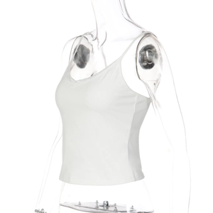 Detailed close-up of white camisole with delicate lace trim and thin shoulder straps