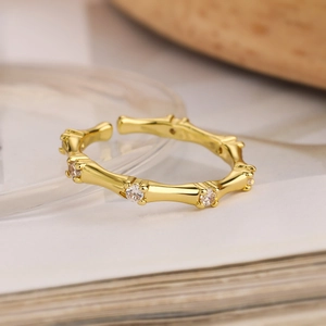 Macro detail of gold plated bamboo style ring with sparkling cubic zirconia accents