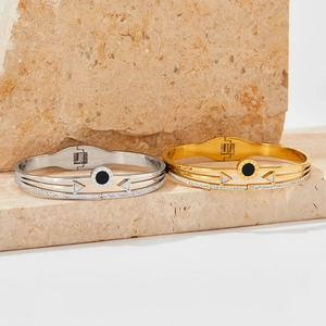 Roman numeral bangles in gold and silver steel with black marble and crystal inlay