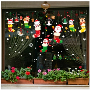 Close-up of festive Christmas window stickers with Santa and reindeer in holiday stockings