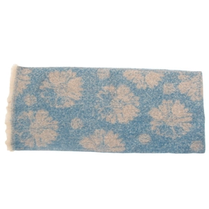 Detail of blue floral jacquard scarf with beige flower pattern and soft fringe edges