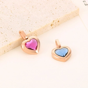 Detail view of heart-shaped rose gold pendants with pink and blue faceted crystals