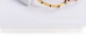 Detailed macro view of gold and rose gold studded bangles with conical rivets