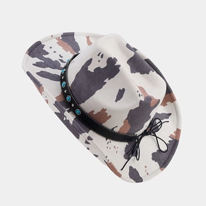 Detailed top view of western cowboy hat with cow print and turquoise studded band