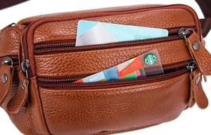 Detail view of brown leather waist bag showing three functional zippered compartments