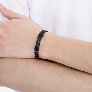 Close-up of black braided stainless steel snake chain bracelet on male wrist